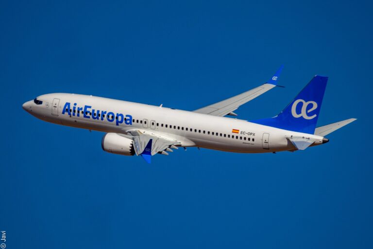 Air Europa aircraft flying in clear blue sky, promoting holiday travel.